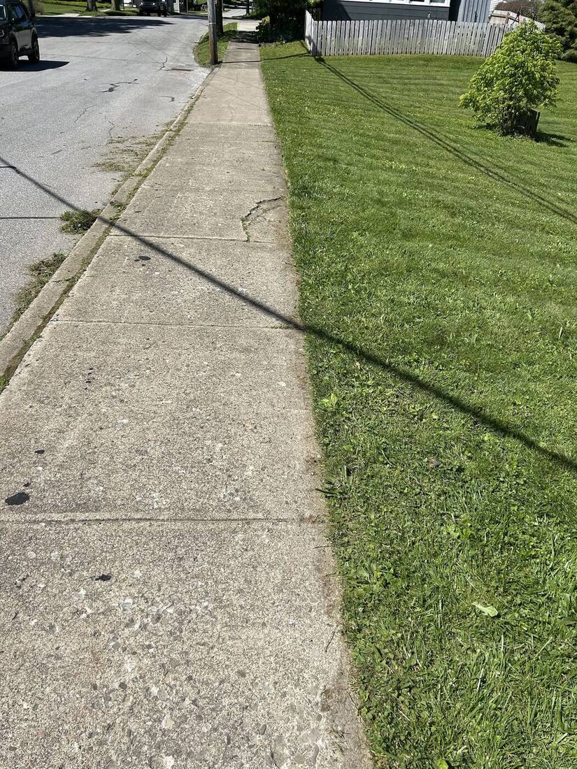 After: sidewalk with a clean edged line and freshly striped lawn